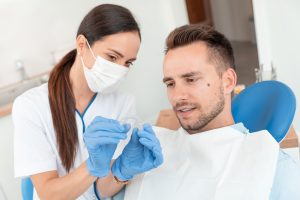 Dentist Shows Invisible Braces Aligner